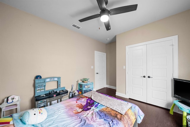 bedroom featuring a closet, ceiling fan, and dark hardwood / wood-style floors