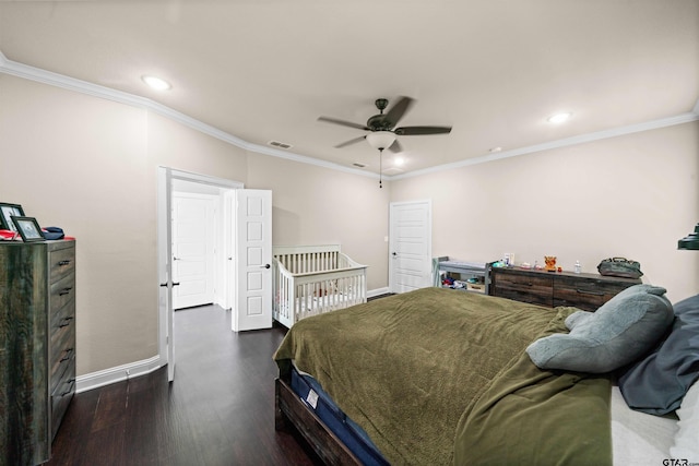 bedroom featuring dark hardwood / wood-style flooring, ceiling fan, and crown molding