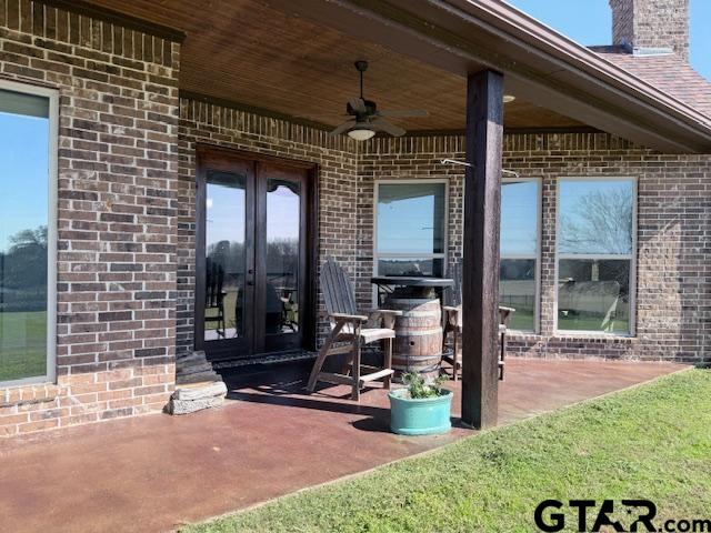 exterior space with french doors and ceiling fan