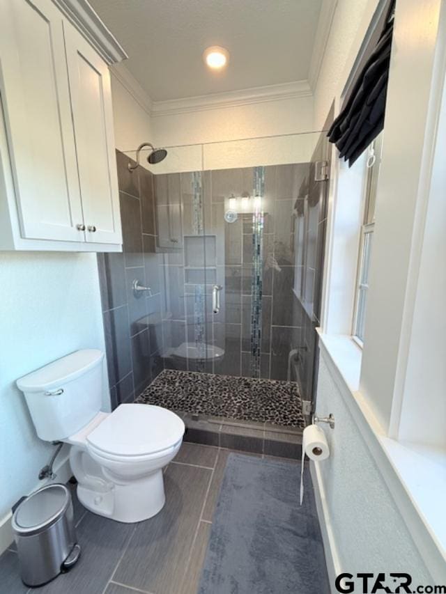 full bath with ornamental molding, a stall shower, and toilet