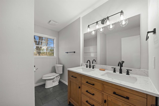 bathroom featuring tile patterned floors, vanity, and toilet