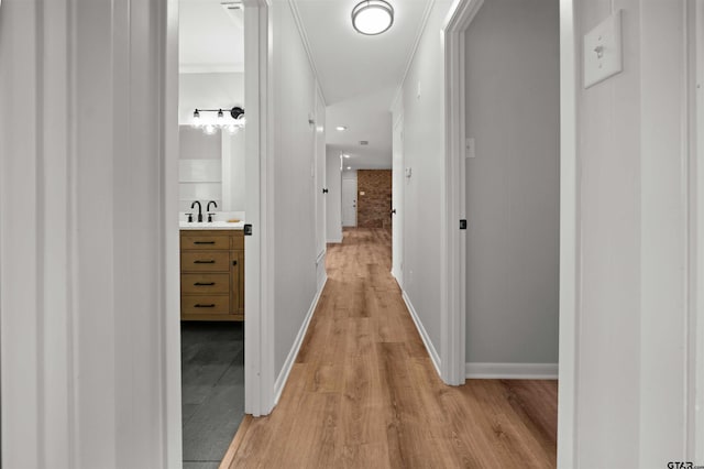 hall featuring sink and light hardwood / wood-style floors