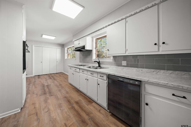 kitchen featuring sink, black appliances, light hardwood / wood-style flooring, decorative backsplash, and white cabinets