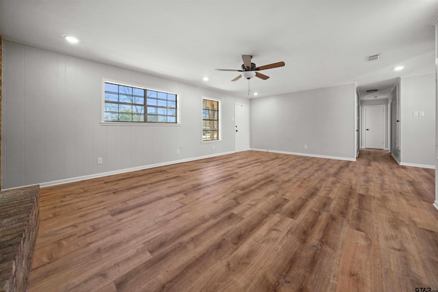 spare room with wood-type flooring and ceiling fan