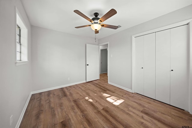 unfurnished bedroom with ceiling fan, light hardwood / wood-style floors, and a closet