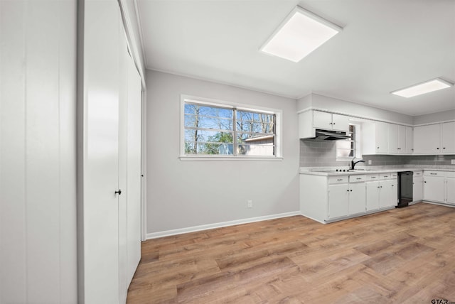 kitchen featuring white cabinetry, light hardwood / wood-style flooring, and backsplash