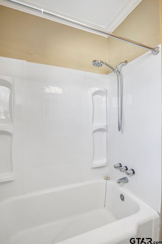 full bathroom featuring  shower combination and ornamental molding