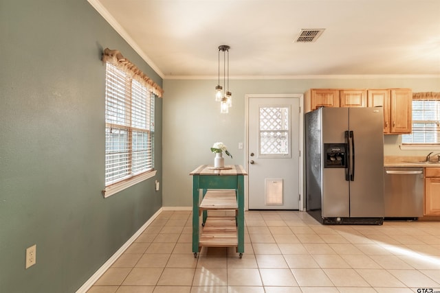 kitchen with light tile patterned flooring, light brown cabinets, ornamental molding, appliances with stainless steel finishes, and pendant lighting