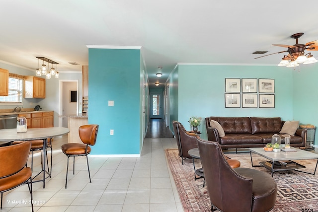 tiled living room featuring sink, ornamental molding, and ceiling fan