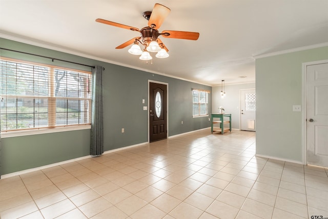 tiled foyer entrance featuring crown molding, ceiling fan, and plenty of natural light