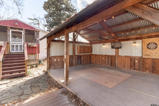 wooden deck with a ceiling fan