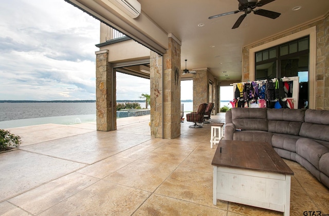 view of patio / terrace with ceiling fan and a water view