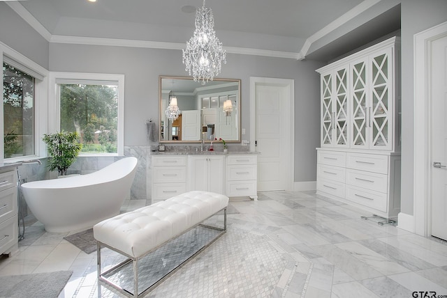 bathroom featuring ornamental molding, a bathtub, vanity, and a chandelier