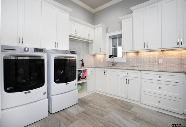 laundry room with cabinets, sink, crown molding, and independent washer and dryer