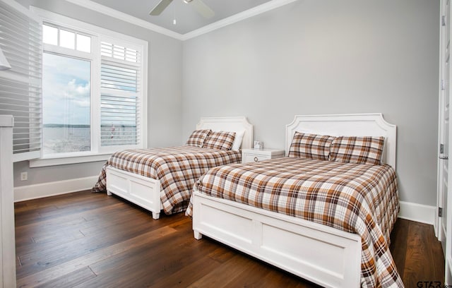 bedroom featuring dark hardwood / wood-style floors, ceiling fan, multiple windows, and ornamental molding