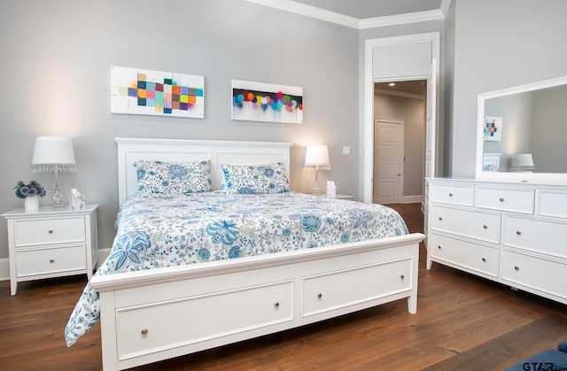 bedroom with dark wood-type flooring and crown molding