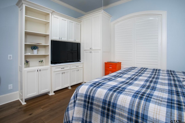 bedroom featuring a closet, dark hardwood / wood-style floors, and crown molding