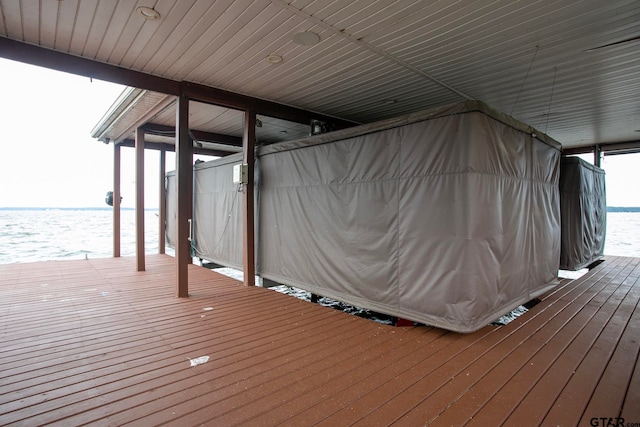 view of dock with a deck with water view