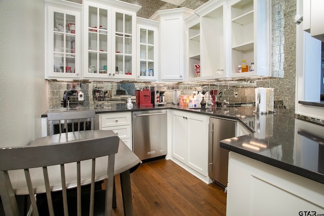 kitchen with white cabinets, dark hardwood / wood-style floors, backsplash, and dishwasher