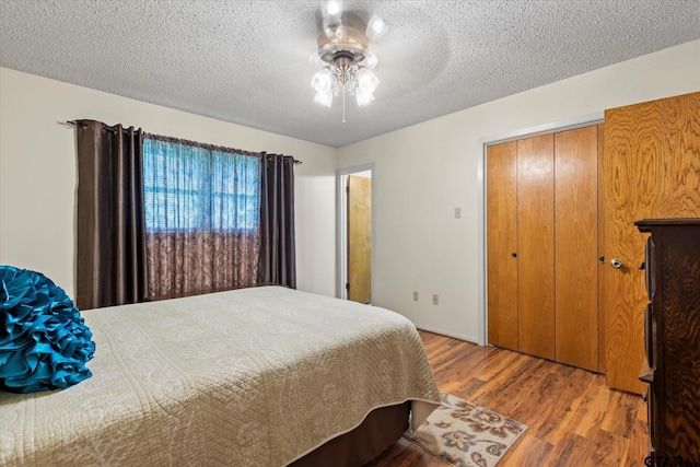 201 Terry St, White Oak, TX 75693 - bedroom featuring wood finished floors, a textured ceiling, and ceiling fan