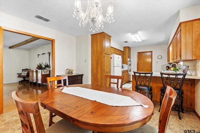 201 Terry St, White Oak, TX 75693 - dining area featuring a chandelier and a textured ceiling