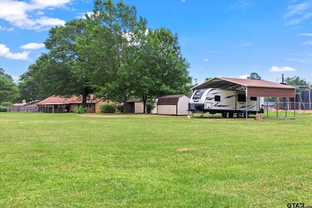 201 Terry St, White Oak, TX 75693 - view of yard featuring a storage unit, a detached carport, and an outdoor structure