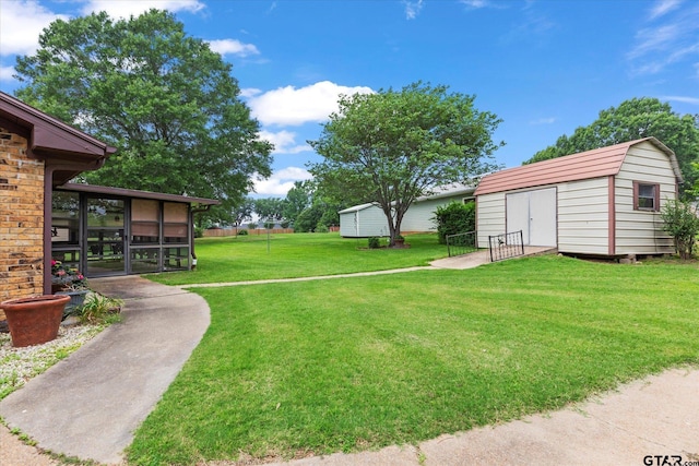 201 Terry St, White Oak, TX 75693 - view of grassy yard featuring a sunroom, a storage shed, and an outbuilding