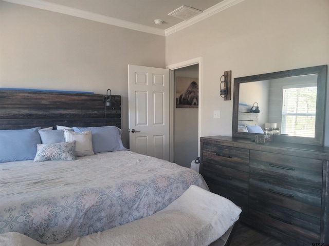 bedroom with ornamental molding and visible vents