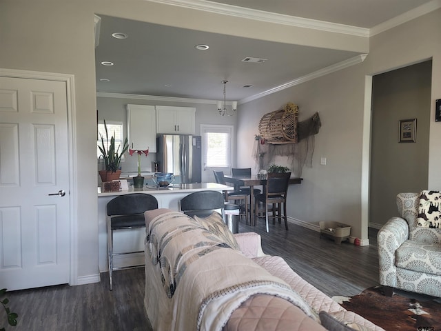 living room featuring dark wood-type flooring and ornamental molding