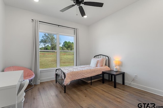 bedroom with hardwood / wood-style floors and ceiling fan