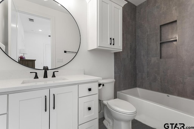 full bathroom featuring vanity, toilet, and tiled shower / bath