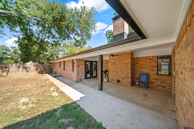 9805 Fm 773, Murchison, TX 75778 - back of property featuring brick siding, fence, a ceiling fan, and a patio area