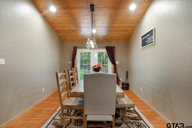 6841 Fm 778, Hawkins, TX 75765 - dining area featuring light wood finished floors, a textured wall, baseboards, and lofted ceiling