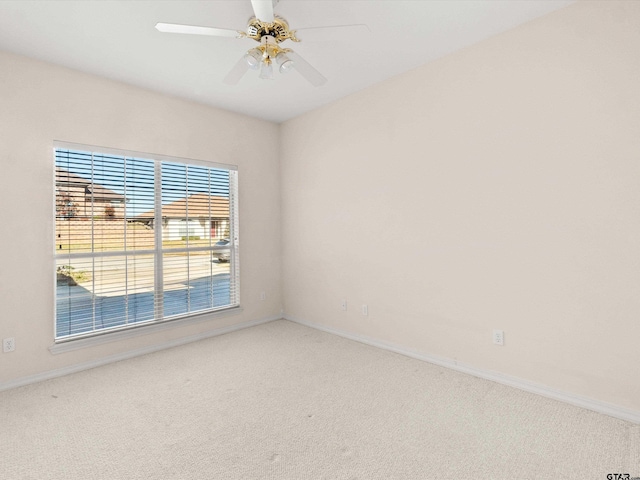 spare room with carpet floors and ceiling fan