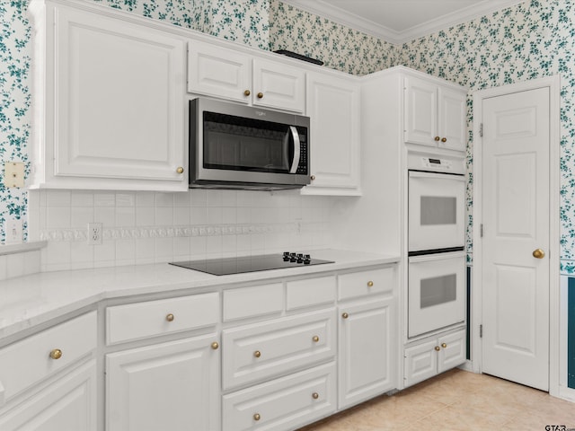 kitchen with black electric cooktop, double oven, and white cabinets