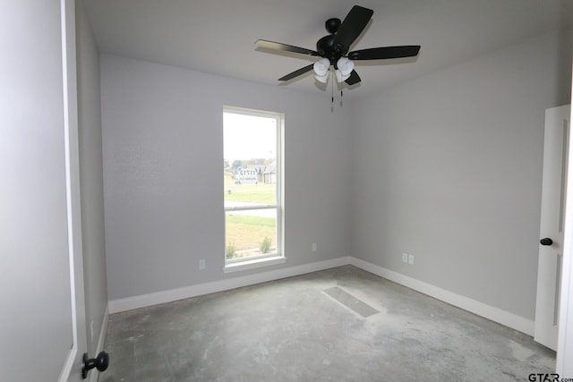 empty room with concrete flooring and ceiling fan