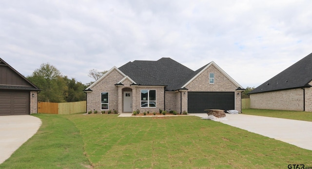 view of front facade with a garage and a front yard