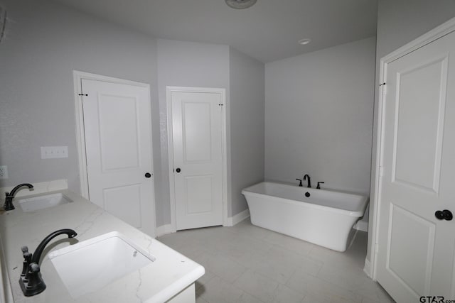 bathroom featuring a bath and vanity