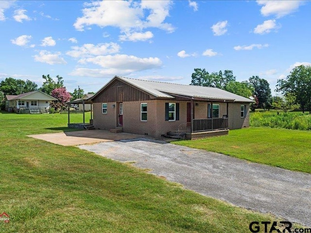 ranch-style home with a front lawn and a carport