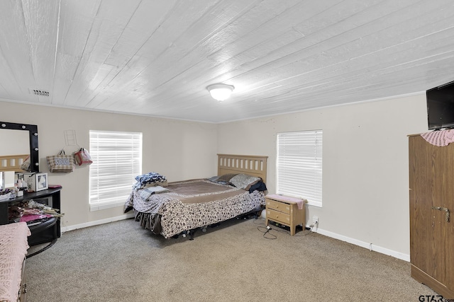 bedroom with carpet flooring and crown molding