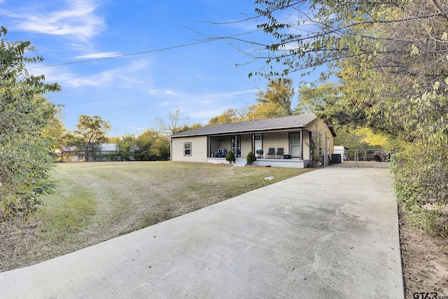 ranch-style house with covered porch and a front lawn