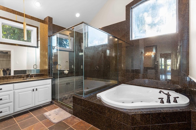 bathroom with tile patterned flooring, shower with separate bathtub, vanity, and vaulted ceiling