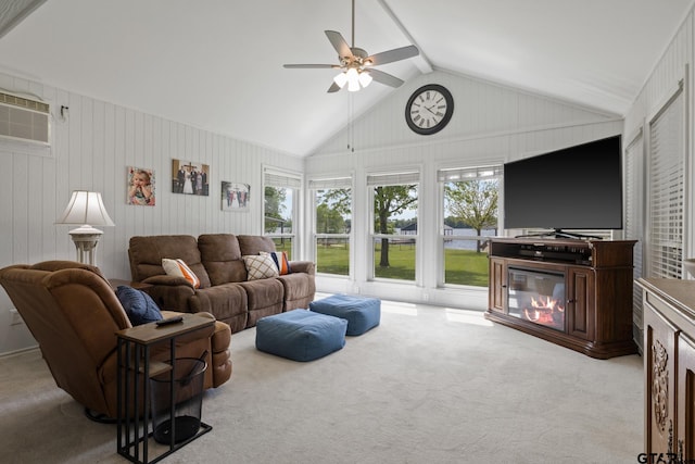 living area with a ceiling fan, carpet flooring, vaulted ceiling, and a healthy amount of sunlight