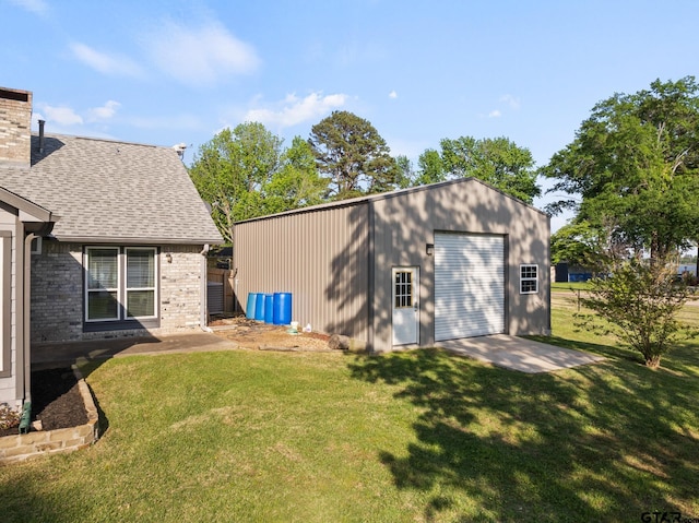 exterior space with a garage and an outbuilding