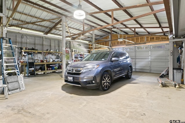 garage featuring a garage door opener and metal wall