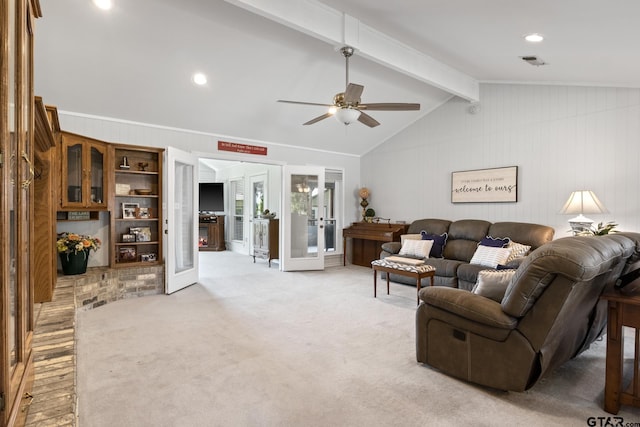 living area with french doors, vaulted ceiling with beams, visible vents, a ceiling fan, and wood walls