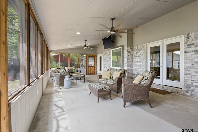 sunroom / solarium featuring a wealth of natural light, a ceiling fan, french doors, and an outdoor hangout area