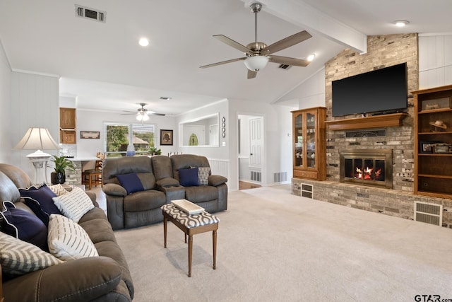 living area with a ceiling fan, visible vents, a fireplace, and carpet flooring