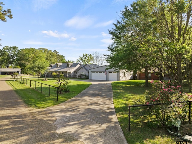 view of front facade featuring concrete driveway, a front lawn, and fence