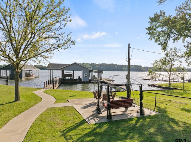view of home's community featuring a yard, a water view, a dock, and boat lift